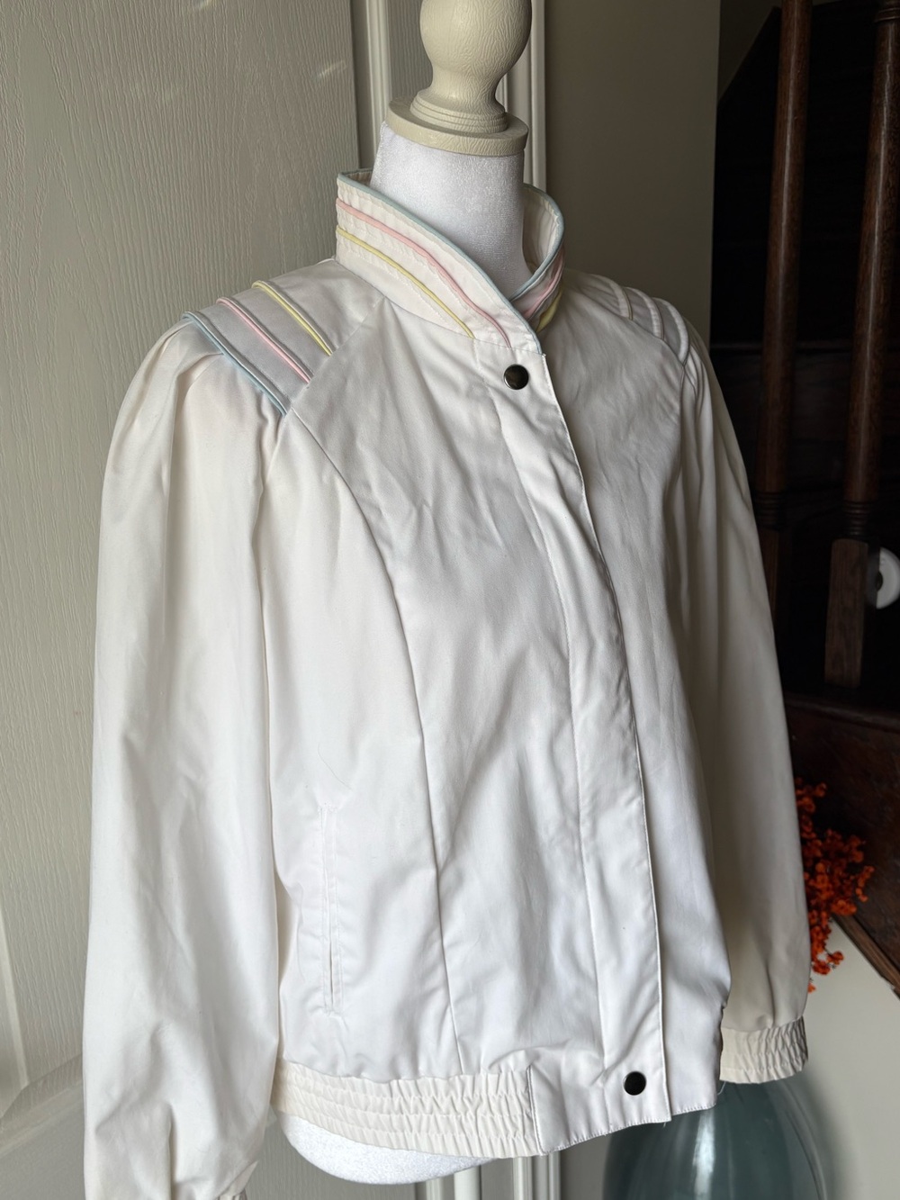 Vintage 1980’s white bomber jacket with pastel piping and high collar